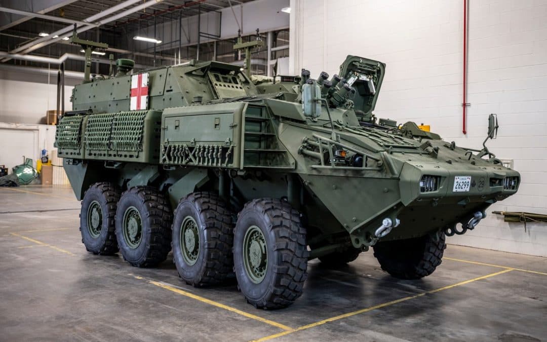 Eight-wheeled armoured military vehicle inside a maintenance facility